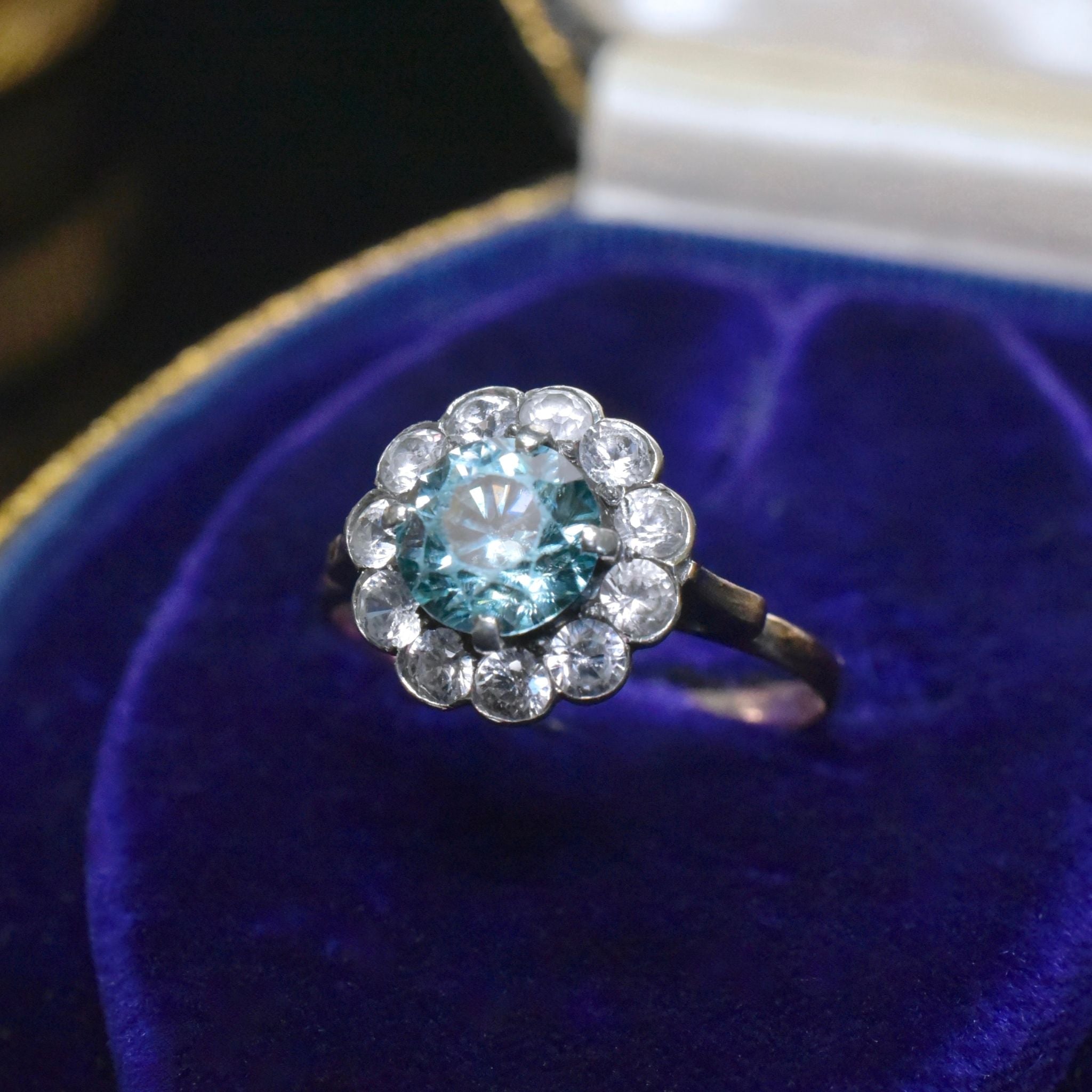 Art Deco Era 9ct Rose Gold Blue Zircon And White Spinel ‘Daisy Halo’ Ring
