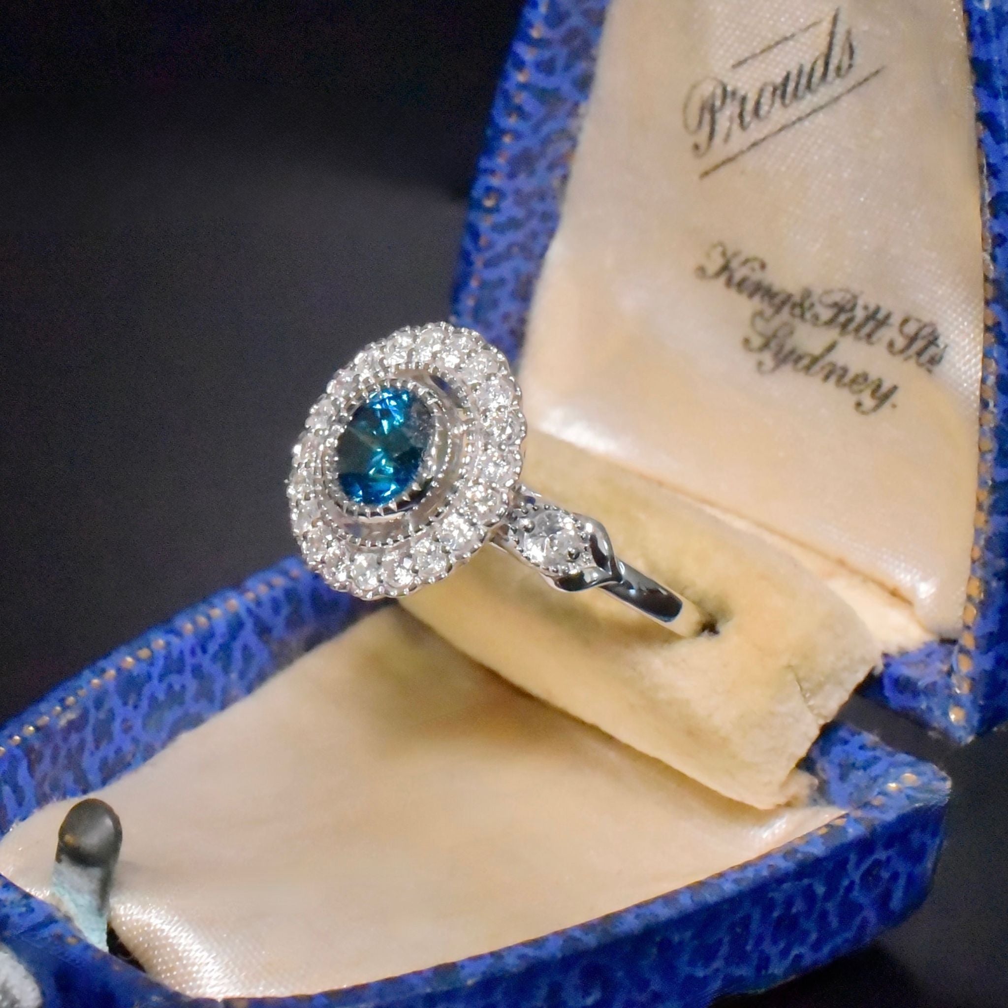 Exquisite 18ct White Gold ‘0.95ct Blue Diamond’ And White Diamond (0.48ct) Halo Ring -  Included In Purchase Valuation For $18,600 AUD