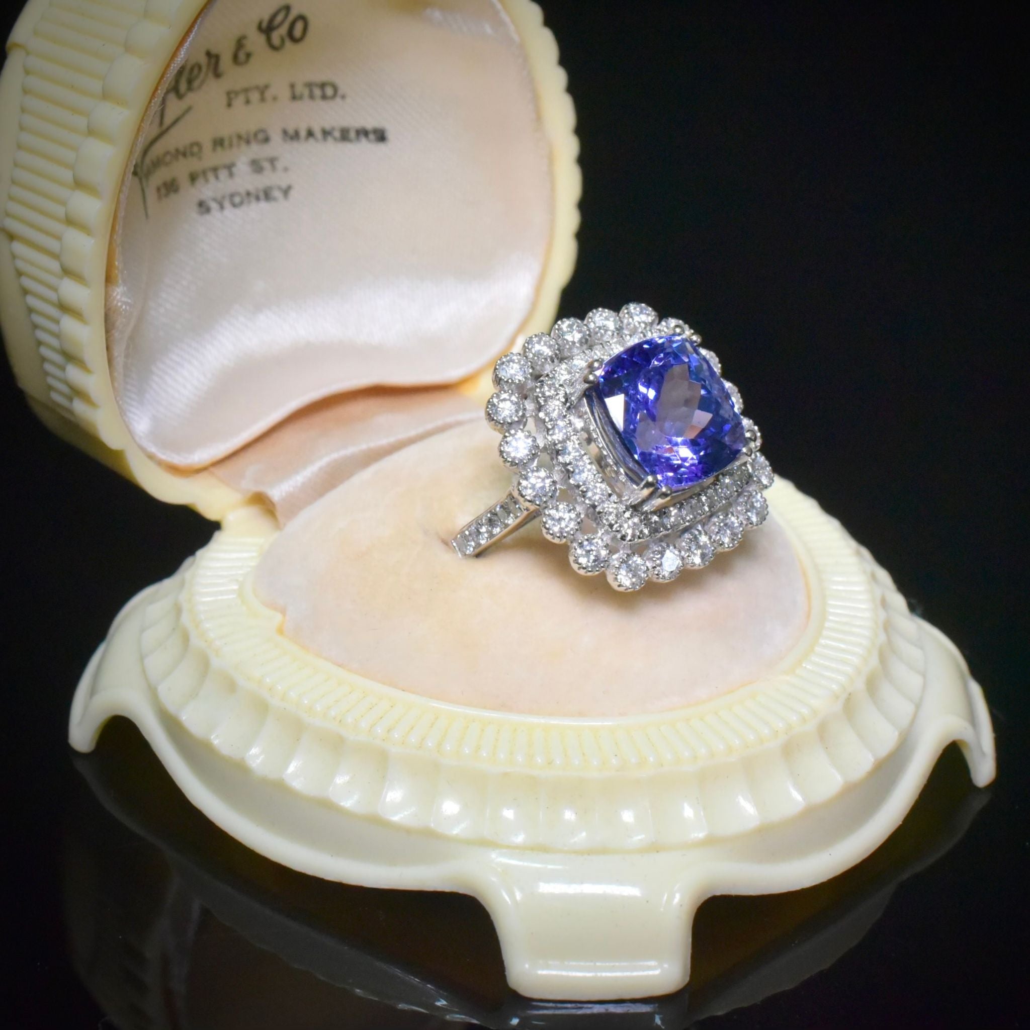Modern 18ct White Gold Tanzanite And Diamond Halo Ring