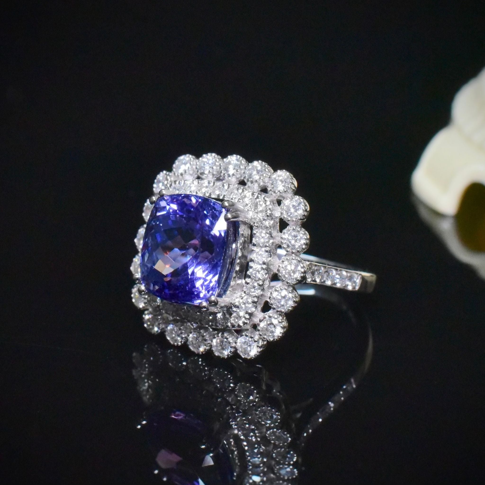 Modern 18ct White Gold Tanzanite And Diamond Halo Ring